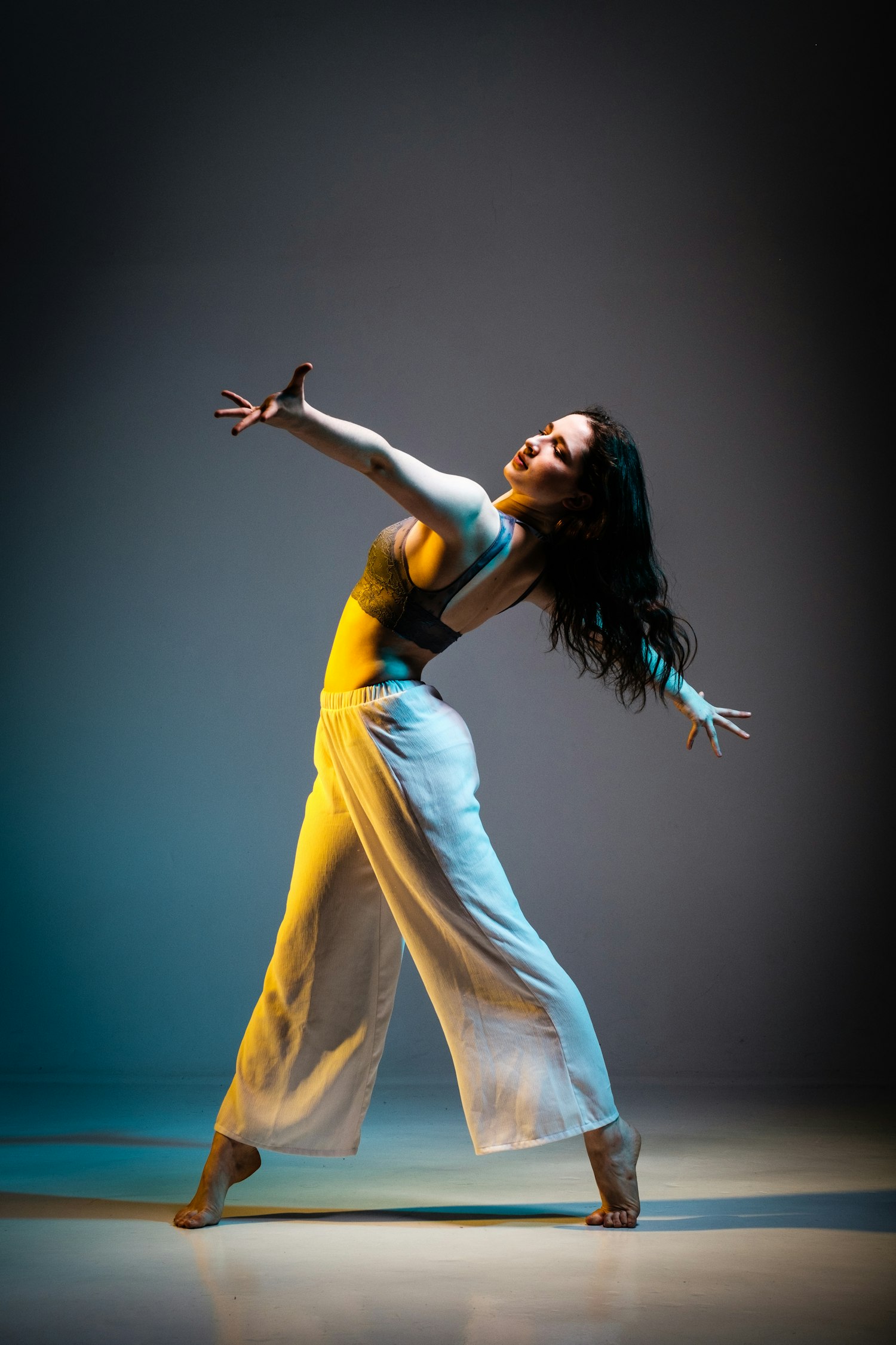 Dancer captured mid movement under stage light